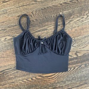 Black crop top with bow detail in center, size M